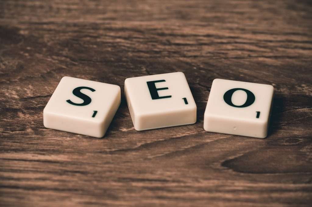 The word seo spelled out on a wooden table.