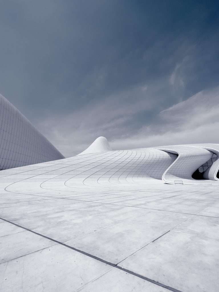 A white building under a cloudy sky.