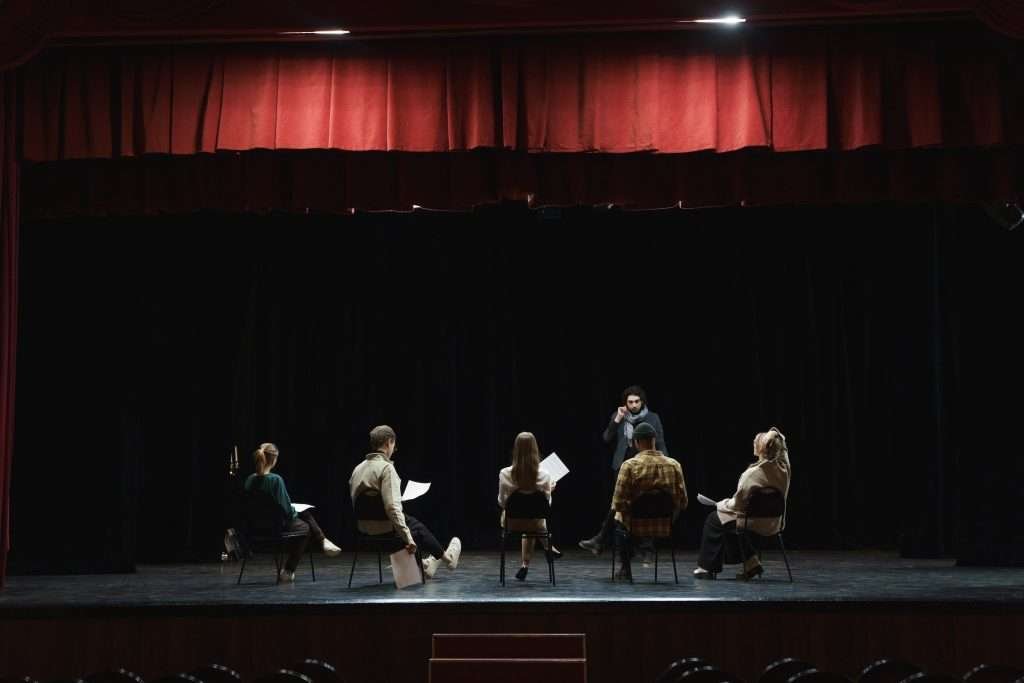 A group of people sitting on chairs in an auditorium.