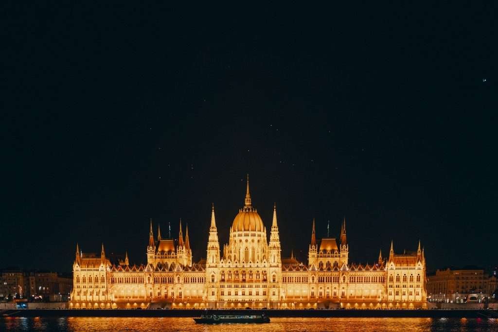 The hungarian parliament building lit up at night.