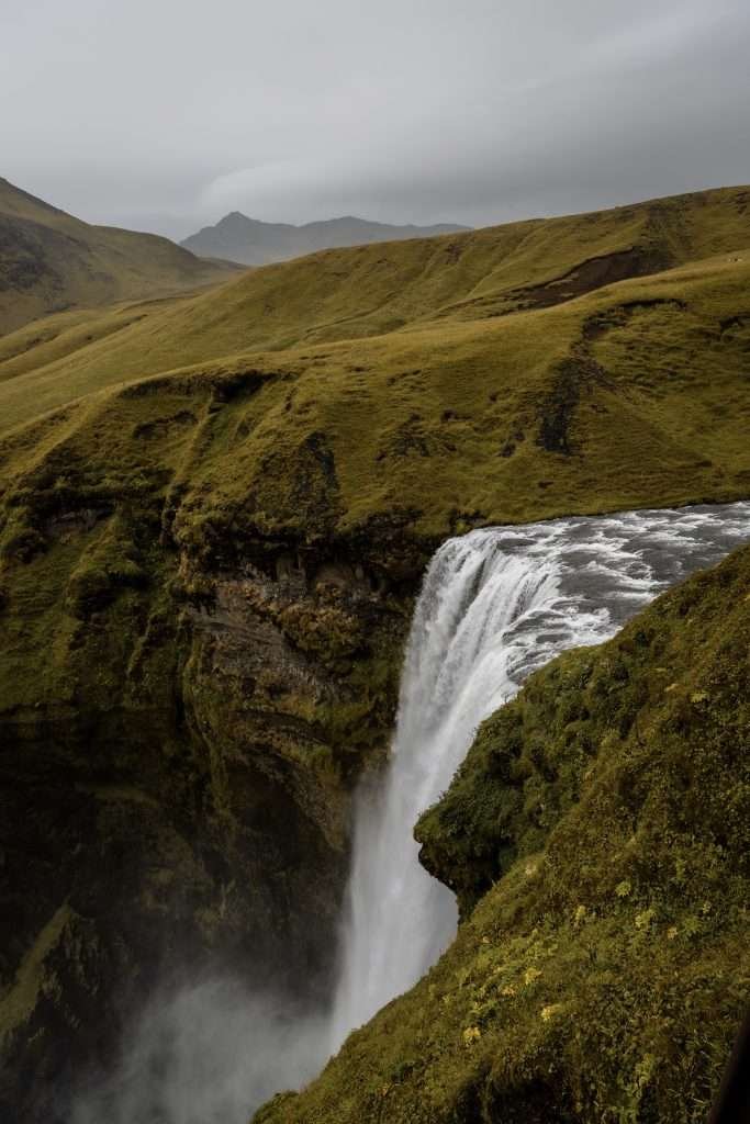 A waterfall in iceland on a cloudy day.