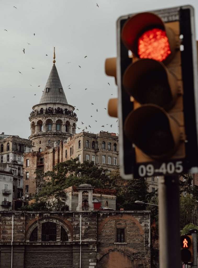 A traffic light in front of a building.