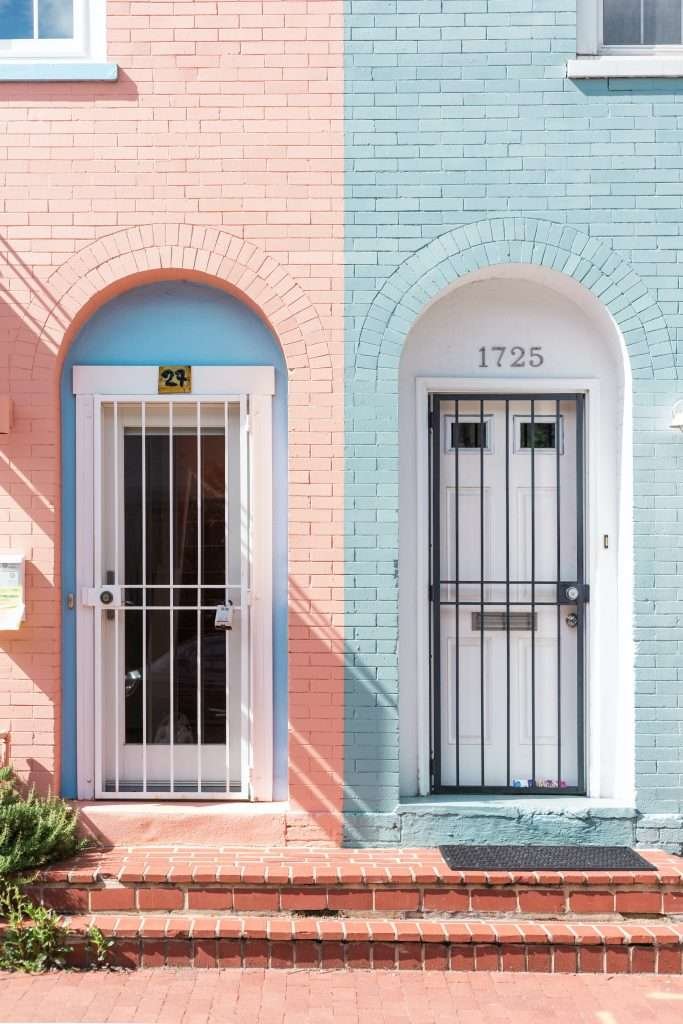Two houses with blue and pink doors.